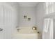 Bathroom featuring a large soaking tub, neutral colors, and relaxing ambiance at 6749 Westlake Blvd, Orlando, FL 32810