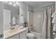 Cozy bathroom featuring a shower-tub combo, a neutral shower curtain, and a single sink vanity with a mirror at 6749 Westlake Blvd, Orlando, FL 32810