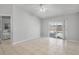 Cozy bedroom featuring tile flooring, light walls, and a sliding glass door to the backyard at 6749 Westlake Blvd, Orlando, FL 32810