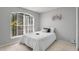 Comfortable bedroom with a bright window and neutral decor at 6749 Westlake Blvd, Orlando, FL 32810