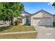 Charming single-story home with a well-manicured lawn and a bright blue front door at 6749 Westlake Blvd, Orlando, FL 32810