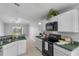Efficient kitchen design featuring bright cabinets and views into the backyard at 6749 Westlake Blvd, Orlando, FL 32810