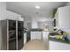 Well-equipped kitchen with modern appliances, light-colored cabinets, and backyard views at 6749 Westlake Blvd, Orlando, FL 32810