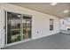Covered outdoor patio with sliding glass doors leading to backyard; ideal spot for relaxation and entertaining at 6749 Westlake Blvd, Orlando, FL 32810