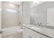 Well-lit bathroom featuring granite countertops, tiled shower, and modern fixtures at 7110 Sw 134Th St, Ocala, FL 34473