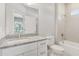 Bright bathroom featuring white cabinets, granite countertops, and a tiled shower and tub combo at 7110 Sw 134Th St, Ocala, FL 34473