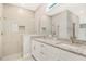 Bright bathroom with a double sink granite vanity and glass enclosed shower at 7110 Sw 134Th St, Ocala, FL 34473