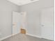 Spacious bedroom with neutral walls, plush carpeting, and three doors at 7110 Sw 134Th St, Ocala, FL 34473