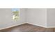 Well-lit bedroom with wood flooring and a window view at 7110 Sw 134Th St, Ocala, FL 34473
