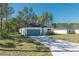 Charming single-story home featuring a well-manicured lawn and a convenient attached two-car garage at 7110 Sw 134Th St, Ocala, FL 34473