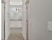 Hallway view of the bathroom featuring a granite vanity top at 7110 Sw 134Th St, Ocala, FL 34473