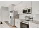 Close up of the kitchen featuring stainless steel appliances, granite countertops, and modern lighting at 7110 Sw 134Th St, Ocala, FL 34473