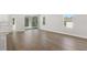 Bright living room with wood floors and sliding glass door to backyard at 7110 Sw 134Th St, Ocala, FL 34473