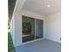 Covered porch with sliding glass doors overlooking a serene outdoor space at 7110 Sw 134Th St, Ocala, FL 34473