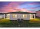 Exterior of home with a well-maintained lawn and inviting covered patio at 804 Colville Dr, Kissimmee, FL 34759