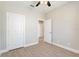 Spacious bedroom featuring tile floors and a door leading to the ensuite bathroom at 804 Colville Dr, Kissimmee, FL 34759