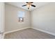 Neutral bedroom featuring wood-look tile flooring and a window at 804 Colville Dr, Kissimmee, FL 34759