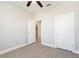 Neutral bedroom featuring wood-look tile flooring and two white doors at 804 Colville Dr, Kissimmee, FL 34759