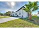 Side view of home boasting fresh landscaping, lush grass, and a long, new driveway at 804 Colville Dr, Kissimmee, FL 34759