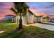 Exterior view of well-kept home showcasing tropical palm tree, and a long driveway at 804 Colville Dr, Kissimmee, FL 34759