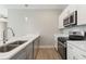 Modern kitchen featuring stainless steel appliances, white cabinetry, and sleek countertops at 804 Colville Dr, Kissimmee, FL 34759