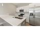 Modern kitchen featuring quartz countertops, stainless appliances, and a large island with dual sinks at 804 Colville Dr, Kissimmee, FL 34759