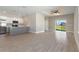 Open concept living area with tile floors, modern kitchen, and a sliding glass door at 804 Colville Dr, Kissimmee, FL 34759