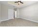 Main bedroom featuring a ceiling fan and a door to the ensuite bathroom at 804 Colville Dr, Kissimmee, FL 34759