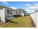 Backyard with green grass and white fence at 819 Featherstone Ln, Lake Mary, FL 32746