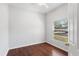 Bright bedroom features hardwood floors and window with blinds at 819 Featherstone Ln, Lake Mary, FL 32746