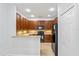 Efficient kitchen featuring granite countertops, dark cabinetry, and modern appliances at 819 Featherstone Ln, Lake Mary, FL 32746