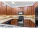 Beautiful kitchen with granite countertops, tile backsplash, and black appliances at 819 Featherstone Ln, Lake Mary, FL 32746