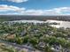 An aerial view showing the property's location near a lake in a green, suburban neighborhood at 859 Windcrest Pl, Winter Springs, FL 32708