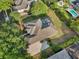 An aerial view shows the home's roof, driveway, a screened-in pool, and private backyard at 859 Windcrest Pl, Winter Springs, FL 32708