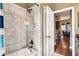 Bright bathroom with a soaking tub and a tiled shower, conveniently located near the kitchen at 859 Windcrest Pl, Winter Springs, FL 32708