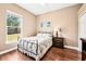 Charming bedroom with wood floors, metal frame bed and a view to the back yard at 859 Windcrest Pl, Winter Springs, FL 32708