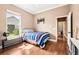 Cozy bedroom with hardwood floors, natural light and a comfortable striped bed at 859 Windcrest Pl, Winter Springs, FL 32708