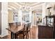 Formal dining room featuring hardwood floors, a chandelier, and views into the living spaces at 859 Windcrest Pl, Winter Springs, FL 32708