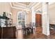 Elegant dining room with hardwood floors, tray ceiling, chandelier and wood door at 859 Windcrest Pl, Winter Springs, FL 32708