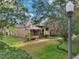 Charming front exterior of home with landscaped yard, beautiful lawn, and mature shade trees at 859 Windcrest Pl, Winter Springs, FL 32708