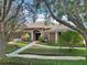 Beautiful home surrounded by mature trees and lush landscaping at 859 Windcrest Pl, Winter Springs, FL 32708