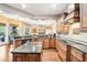 Well-appointed kitchen with a central island, granite countertops, and custom cabinetry at 859 Windcrest Pl, Winter Springs, FL 32708