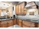 A gourmet kitchen features granite countertops, wood cabinets, and stainless steel appliances at 859 Windcrest Pl, Winter Springs, FL 32708