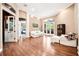 Bright living room featuring hardwood floors, neutral paint, white furniture and arched doorways at 859 Windcrest Pl, Winter Springs, FL 32708