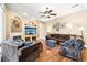 Comfortable living room with fireplace, mounted TV and a cozy brown sectional sofa at 859 Windcrest Pl, Winter Springs, FL 32708