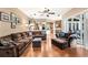 Spacious living room with hardwood floors, ample seating, and sliding glass doors to the outdoors at 859 Windcrest Pl, Winter Springs, FL 32708