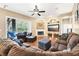 Comfortable living room with built-in shelving, a fireplace, and a sliding door to the outdoor screened area at 859 Windcrest Pl, Winter Springs, FL 32708
