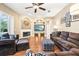 Cozy living room with a fireplace, large windows, and comfortable seating at 859 Windcrest Pl, Winter Springs, FL 32708