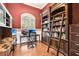 Home office with a built-in bookcase, hardwood floors, and a cozy reading nook at 859 Windcrest Pl, Winter Springs, FL 32708