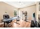 Home office featuring wood floors, neutral walls, and a minimalist decor style at 859 Windcrest Pl, Winter Springs, FL 32708